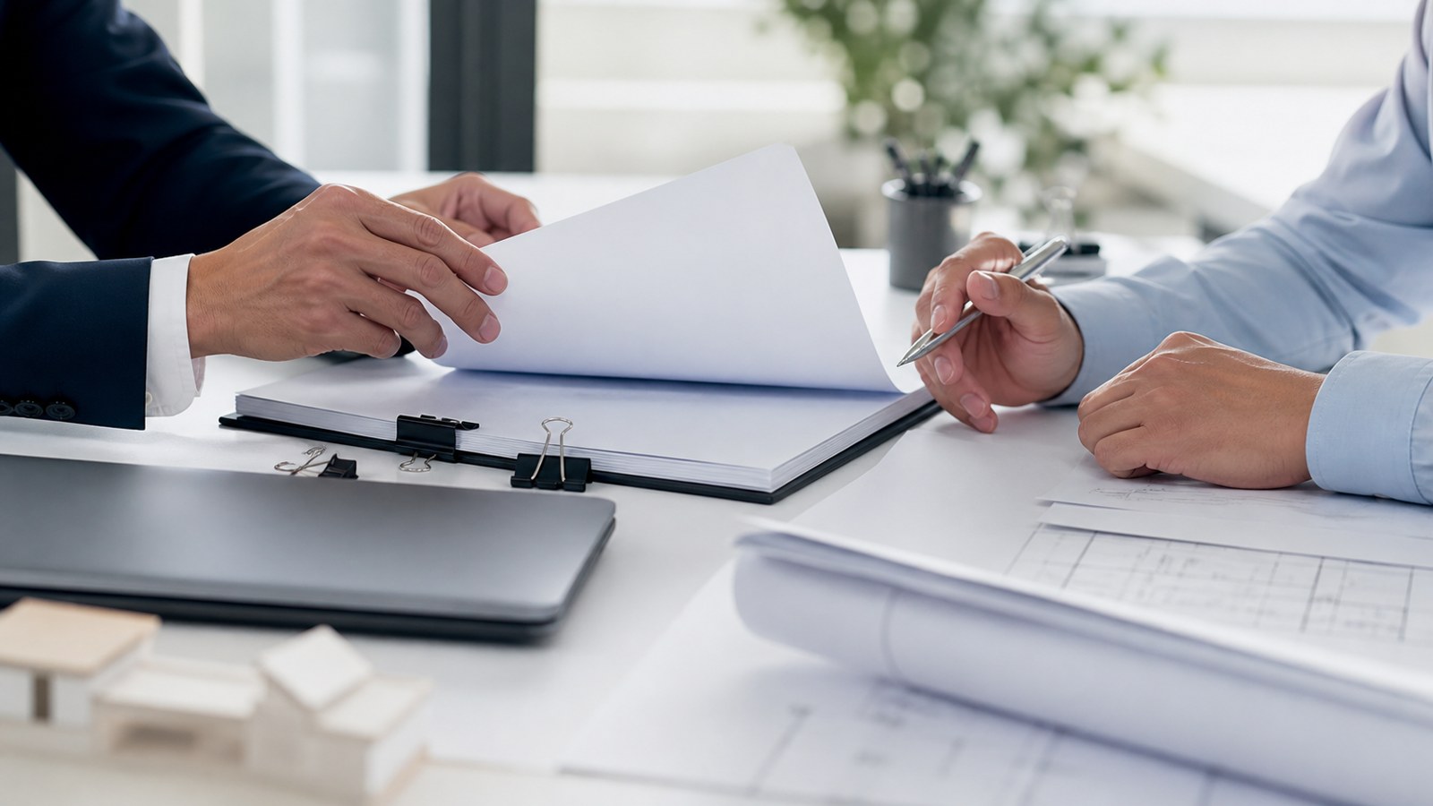 Business borrower hands reviewing commercial lending paperwork